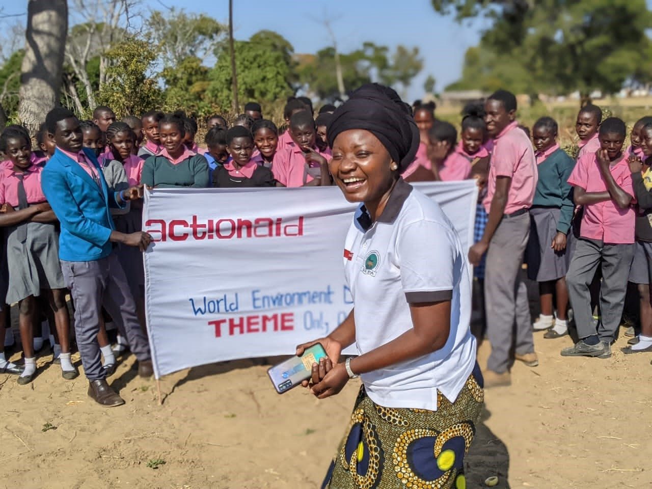 Pupils and a SEPA facilitator holding a World Environment Day banner