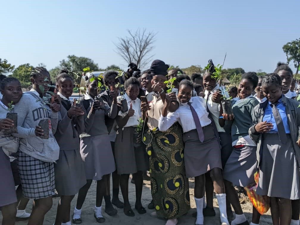 A large group of school pupils gathered outdoors
