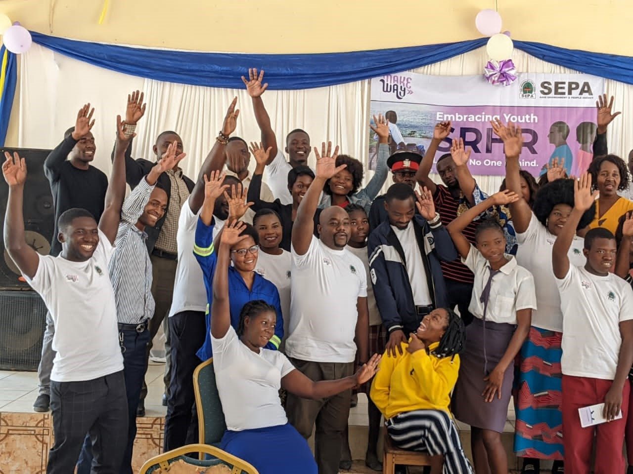 Young people raising their hands in celebration at a SEPA event